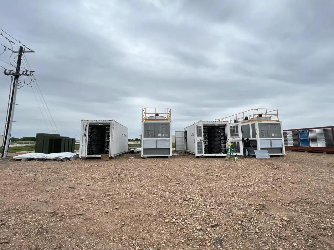 Exterior of a large-scale mining farm showcasing rows of cooling fans and security fencing